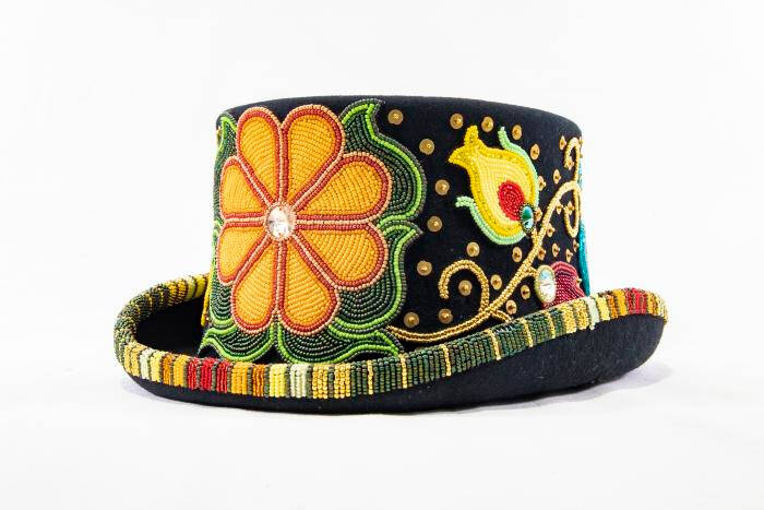 Black top hat with floral beaded applique. There are no beads on the top of the hat, but on the sides and rim of the hat.